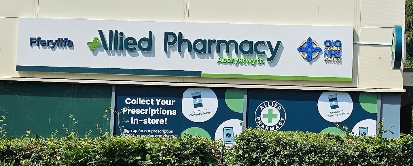 Allied Pharmacy shop front with a fascia sign and window graphics made by Select Print