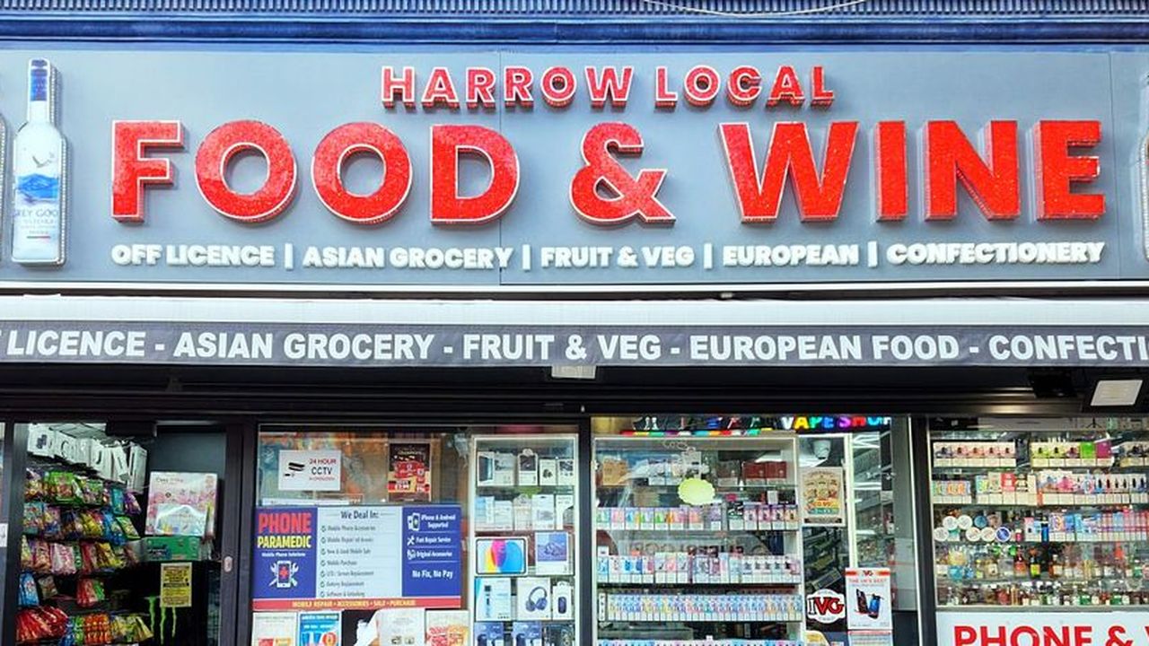 Harrow Local Food & Wine shop front by day with red letters and bottle-shaped light boxes